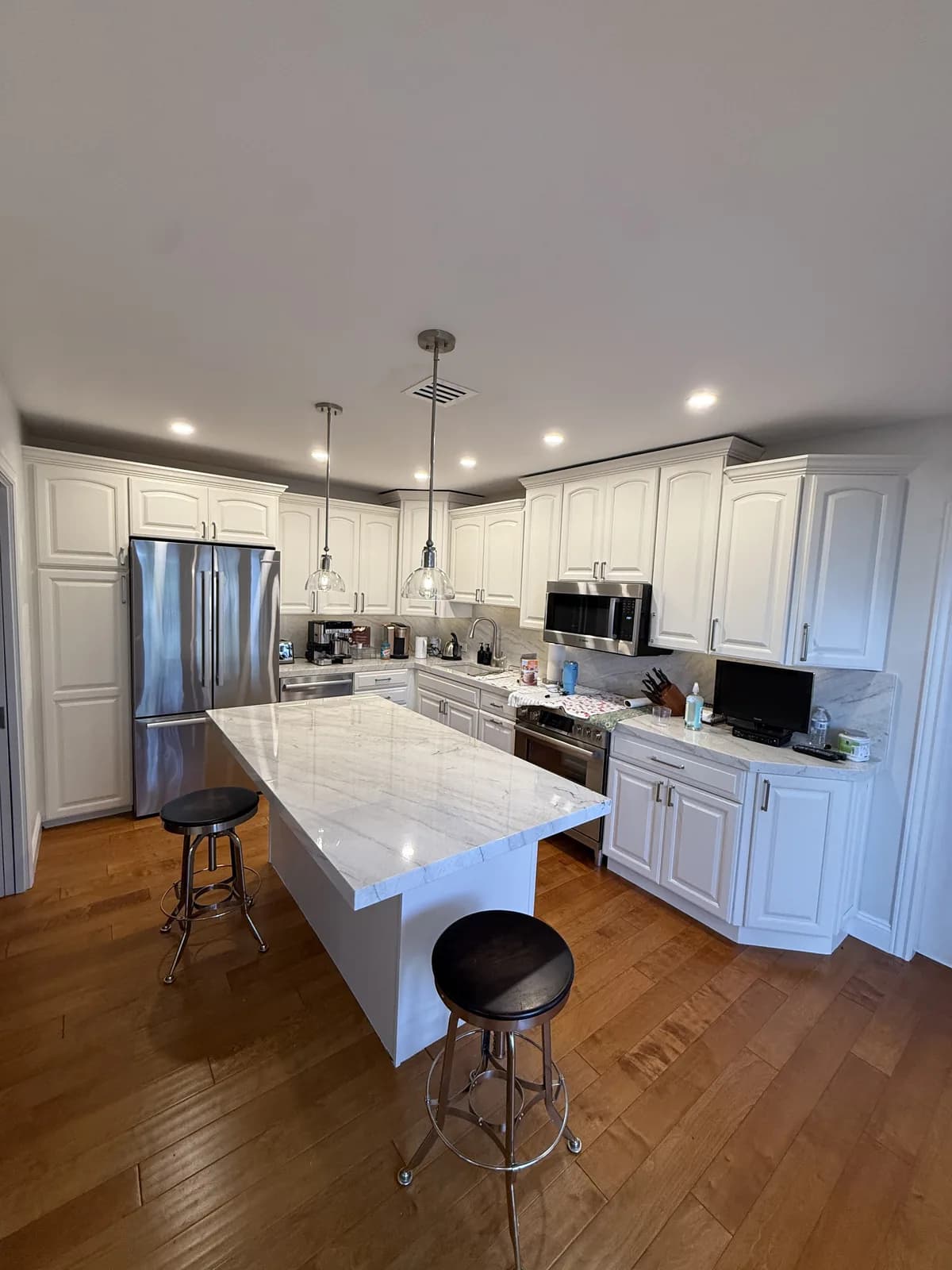 White cabinets with marble island